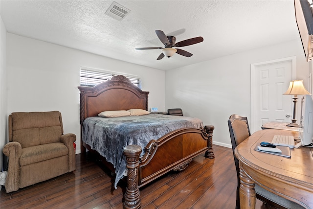 bedroom with a textured ceiling, ceiling fan, and dark wood-type flooring