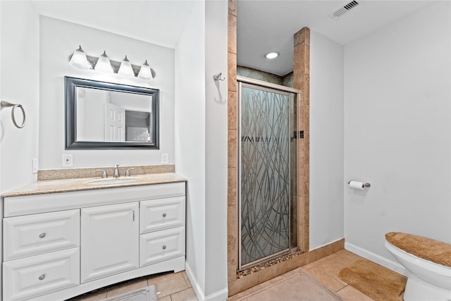 bathroom featuring vanity, tile patterned floors, toilet, and walk in shower