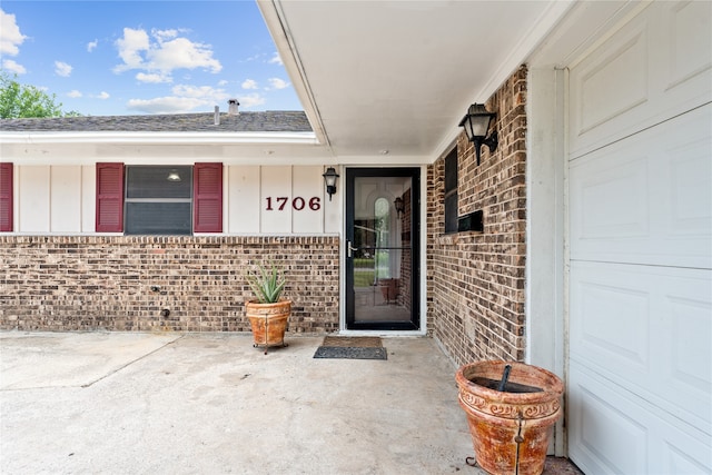 view of exterior entry with a garage