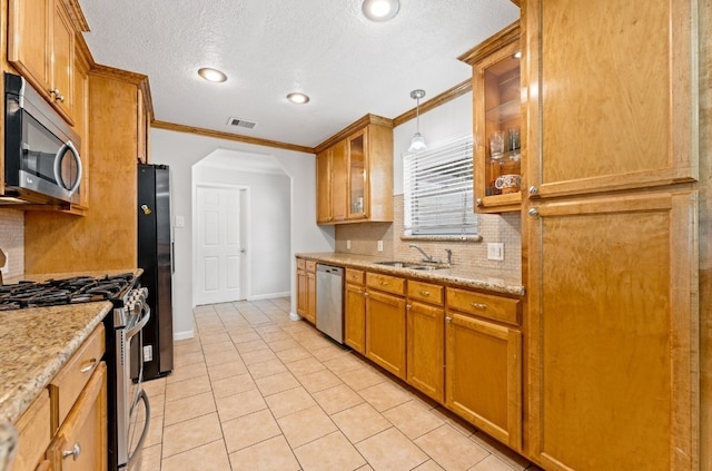 kitchen featuring tasteful backsplash, appliances with stainless steel finishes, light tile patterned floors, and pendant lighting