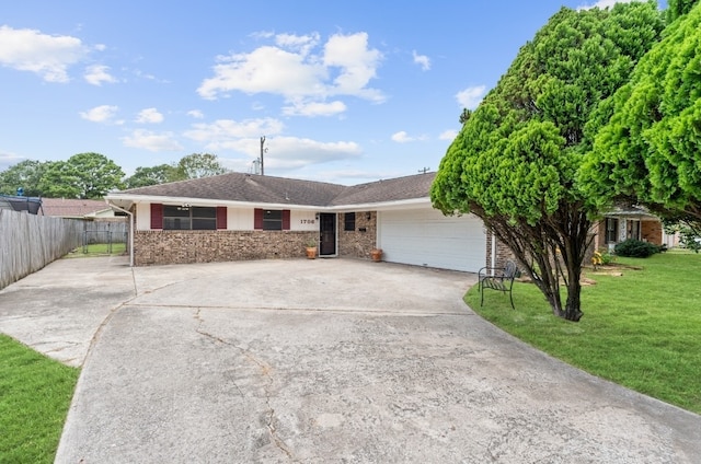 single story home featuring a garage and a front yard