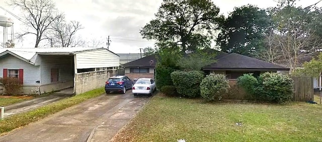 view of front of property with a front yard and a carport