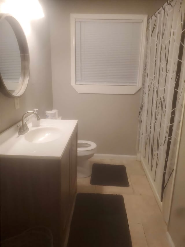 bathroom featuring walk in shower, tile patterned flooring, vanity, and toilet