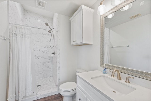 bathroom with a shower with shower curtain, vanity, wood-type flooring, and toilet