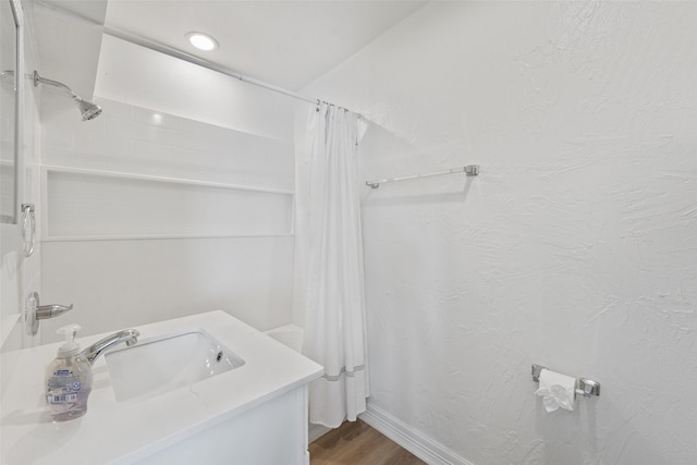 bathroom featuring shower / bath combo, vanity, and hardwood / wood-style flooring