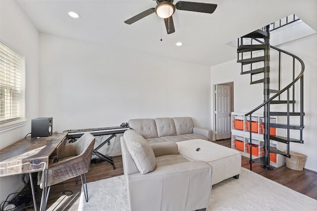 living room featuring ceiling fan and wood-type flooring