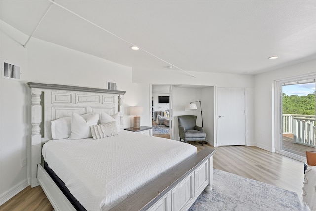 bedroom featuring access to outside and light hardwood / wood-style floors