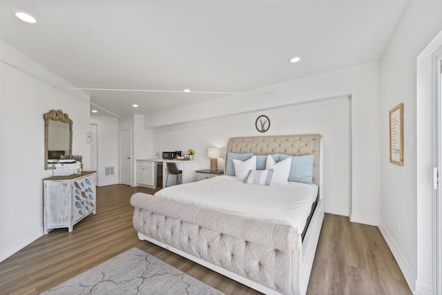 bedroom with wood-type flooring