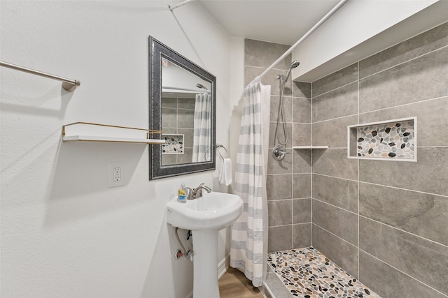 bathroom featuring a shower with shower curtain and hardwood / wood-style flooring