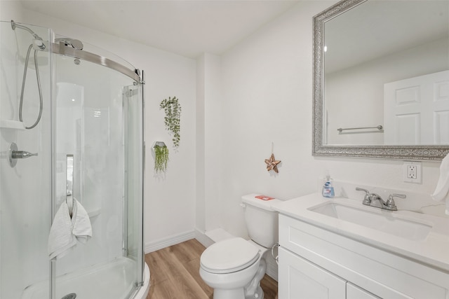 bathroom with walk in shower, wood-type flooring, vanity, and toilet