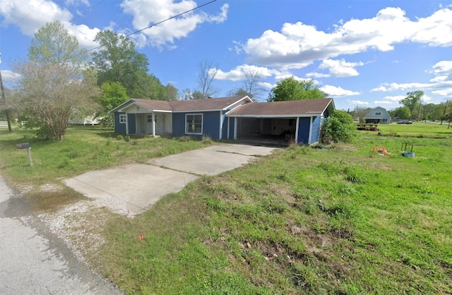 ranch-style house featuring a carport and a front lawn