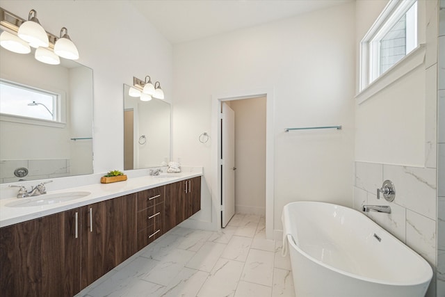 bathroom featuring plenty of natural light, tile flooring, vanity with extensive cabinet space, and double sink