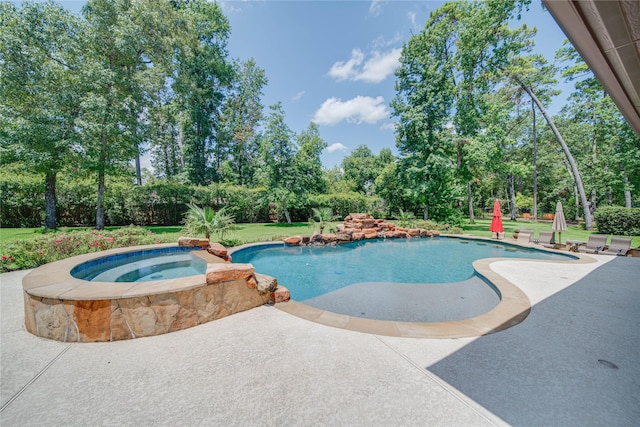 view of pool with a patio area and an in ground hot tub