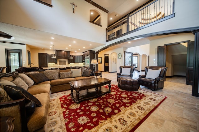 living room featuring ornamental molding and a high ceiling