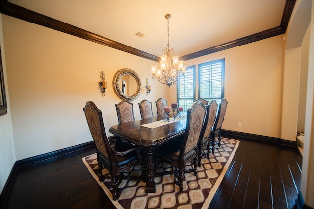 dining room featuring dark hardwood / wood-style floors, ornamental molding, and a chandelier