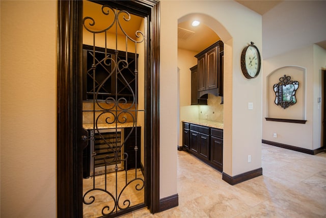 interior space with tasteful backsplash and dark brown cabinets