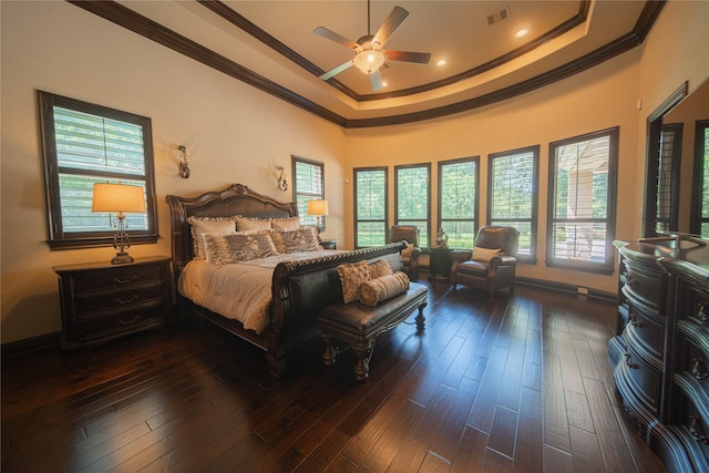 bedroom featuring a tray ceiling, ceiling fan, crown molding, and dark hardwood / wood-style floors