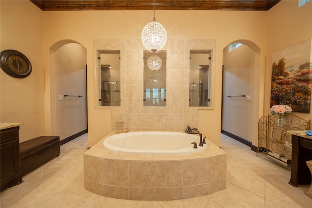 bathroom featuring ornamental molding, vanity, a relaxing tiled tub, an inviting chandelier, and tile patterned flooring