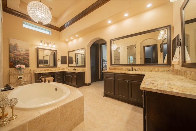 bathroom featuring tiled tub, vanity, a high ceiling, and a notable chandelier