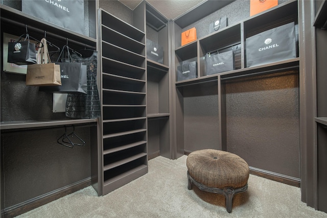 walk in closet featuring carpet flooring