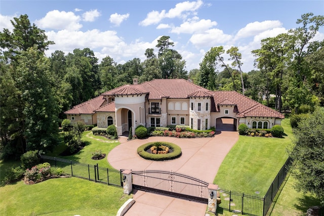 mediterranean / spanish-style house featuring a garage and a front lawn