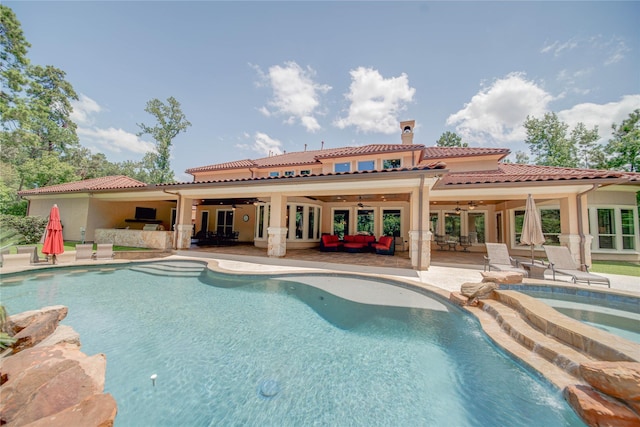 view of pool featuring outdoor lounge area, ceiling fan, an in ground hot tub, and a patio