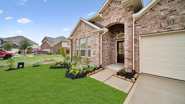 view of front of house featuring a garage and a front lawn