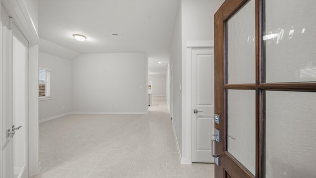 hall featuring lofted ceiling