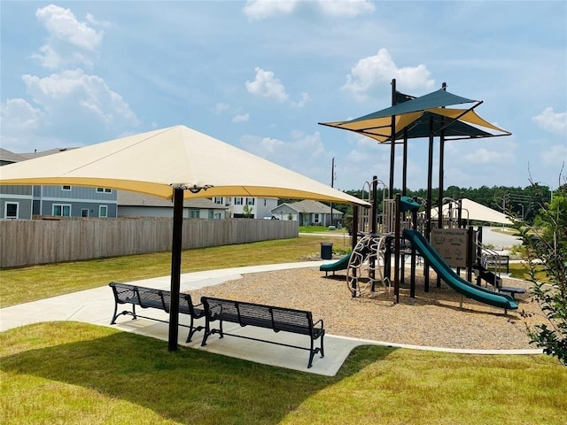 view of jungle gym featuring a lawn