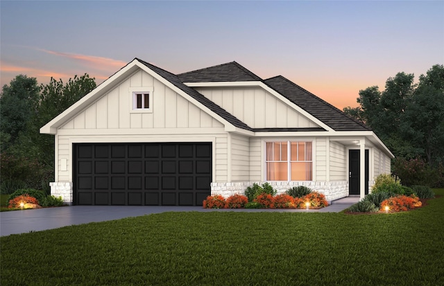 view of front of house featuring a garage and a yard