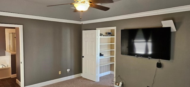 interior space with ceiling fan, carpet flooring, and ornamental molding