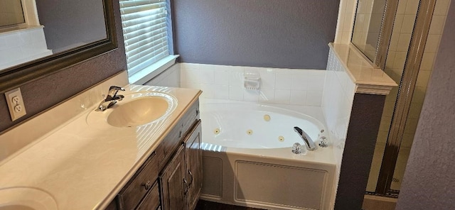 bathroom featuring dual bowl vanity and separate shower and tub