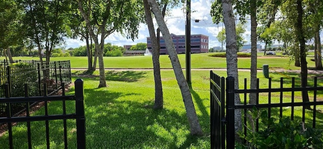 view of gate with a lawn