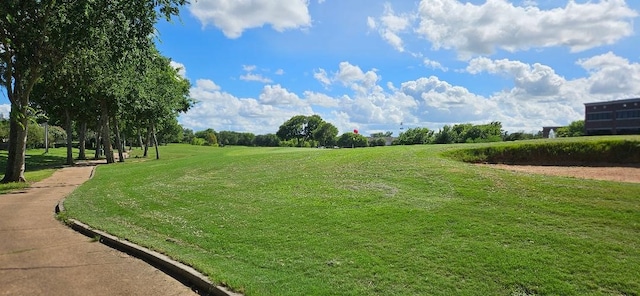 view of property's community with a lawn