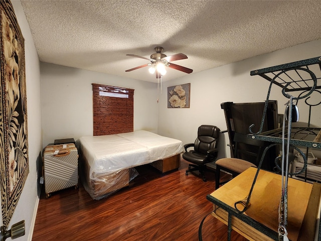 bedroom with a ceiling fan, dark wood finished floors, and a textured ceiling