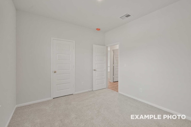 unfurnished bedroom with light carpet