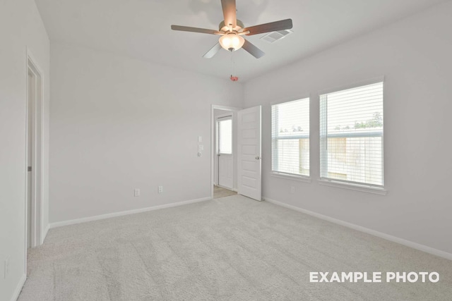 empty room featuring light carpet and ceiling fan