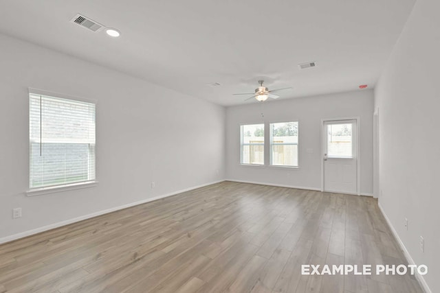 empty room with ceiling fan and light wood-type flooring