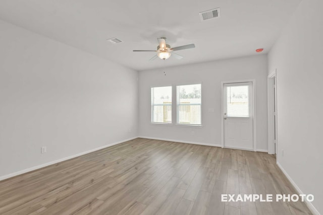 empty room with light hardwood / wood-style floors and ceiling fan