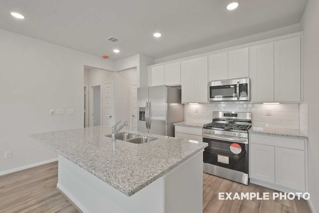 kitchen featuring white cabinetry, appliances with stainless steel finishes, sink, and light hardwood / wood-style floors