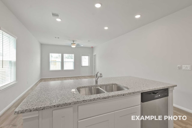 kitchen featuring ceiling fan, white cabinetry, stainless steel dishwasher, light wood-type flooring, and sink