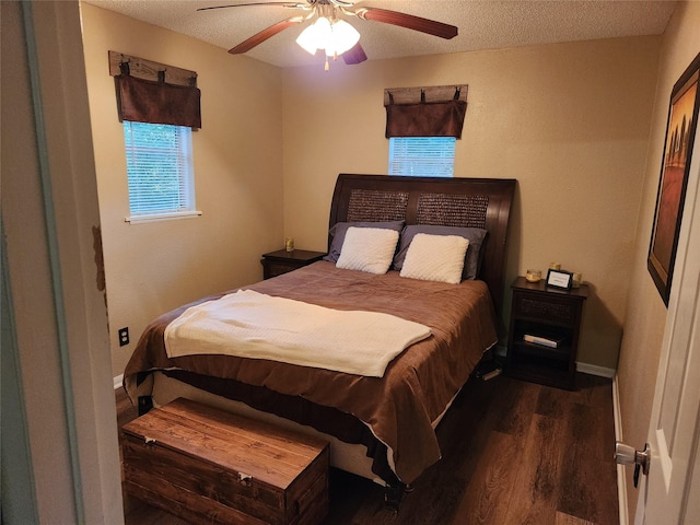 bedroom with ceiling fan, dark hardwood / wood-style flooring, and a textured ceiling