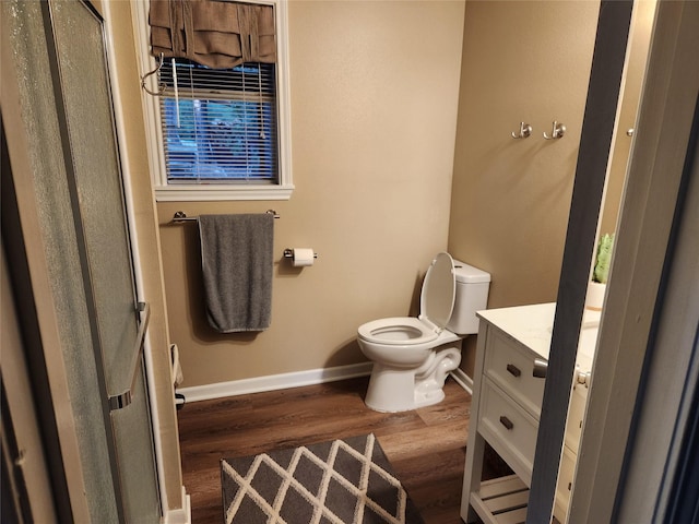 bathroom with vanity, hardwood / wood-style flooring, and toilet