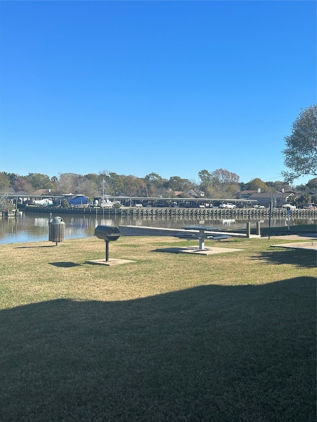 exterior space with a water view and a yard