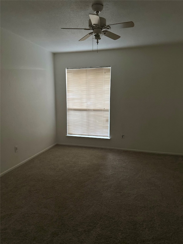 carpeted spare room with a textured ceiling and ceiling fan