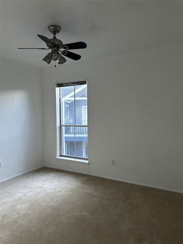 spare room with carpet and ceiling fan