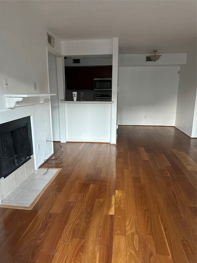 unfurnished living room with wood-type flooring