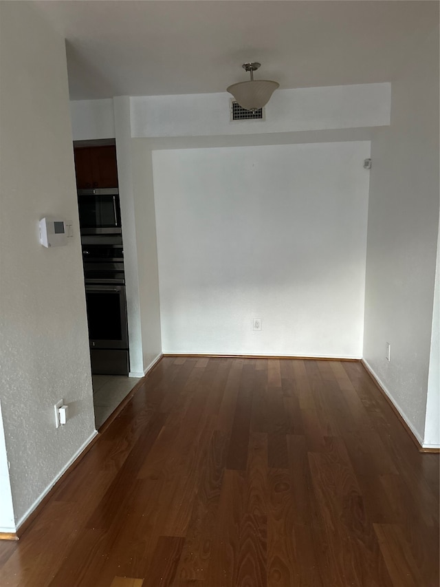 spare room featuring dark hardwood / wood-style floors