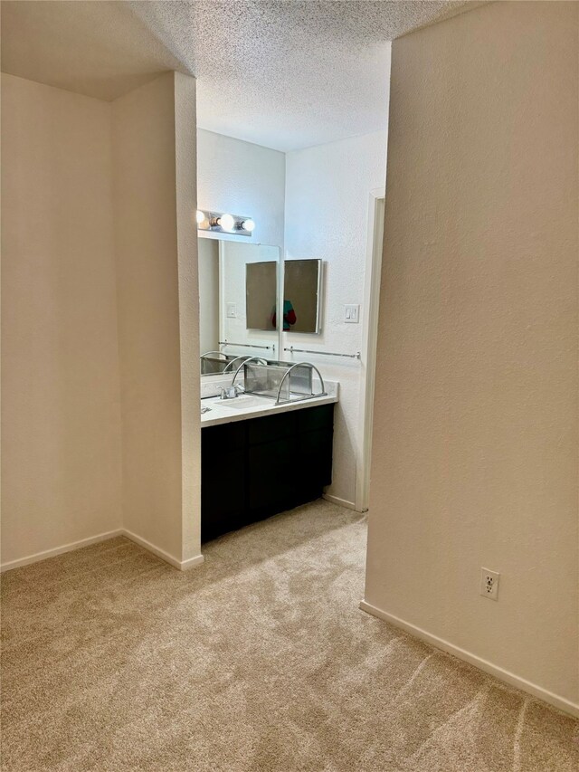 bathroom featuring a textured ceiling and vanity