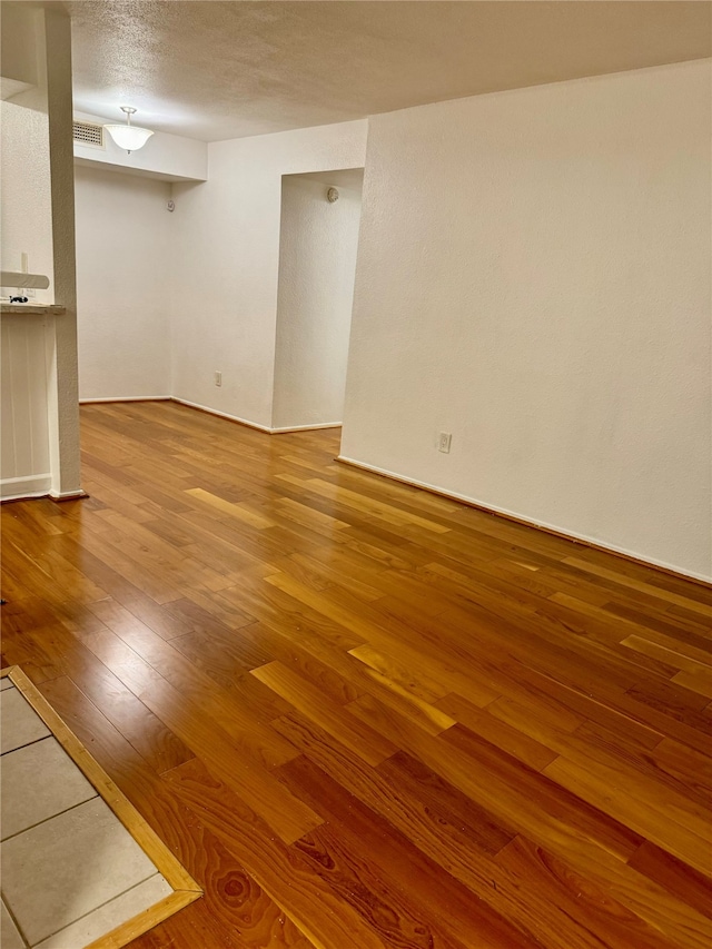 interior space featuring hardwood / wood-style floors and a textured ceiling